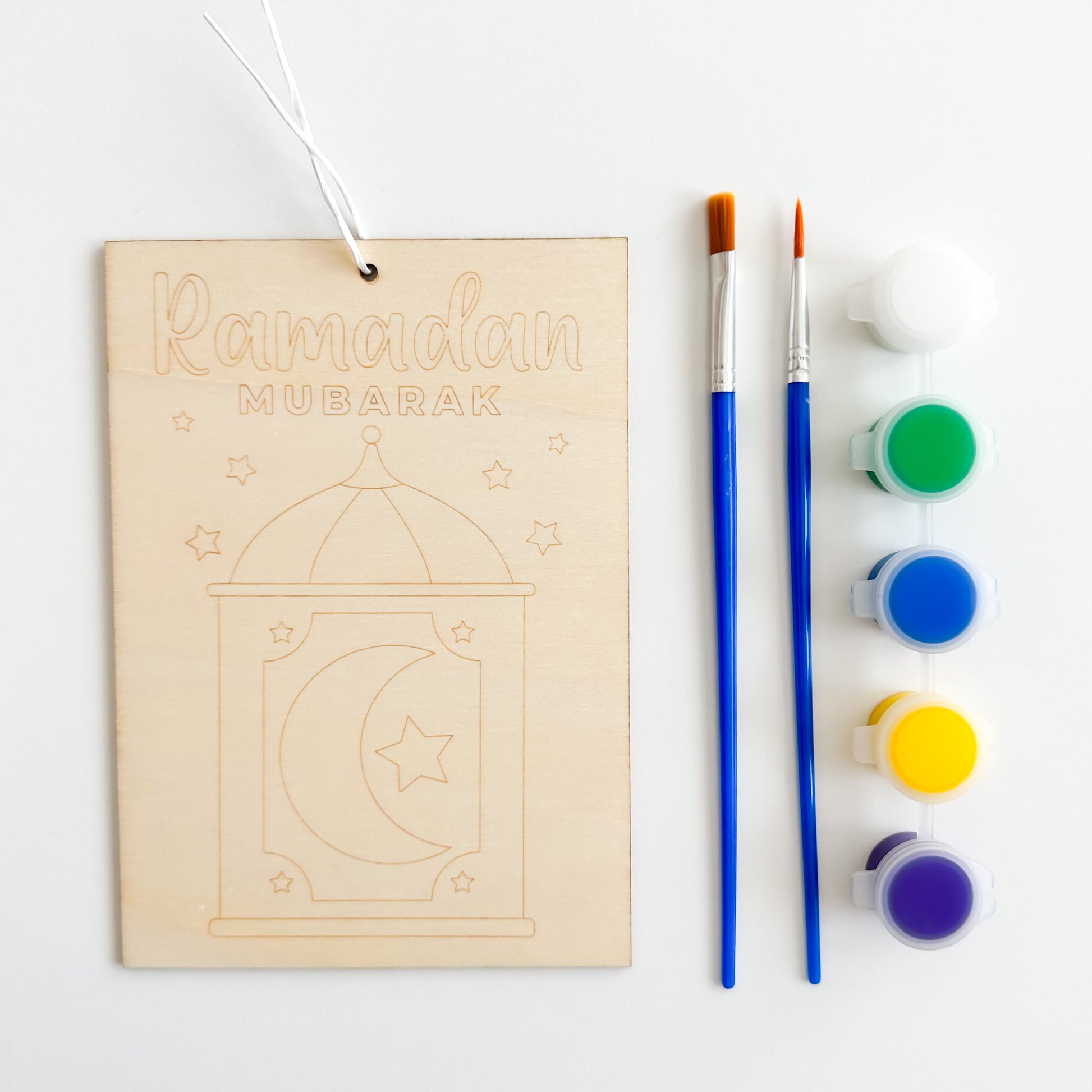 A set of wood painting kits including canvas pieces, brushes, and paint in multiple colors.