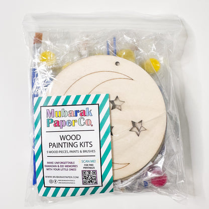 Wood painting kit with wooden circle, stars, and paint supplies in clear packaging.